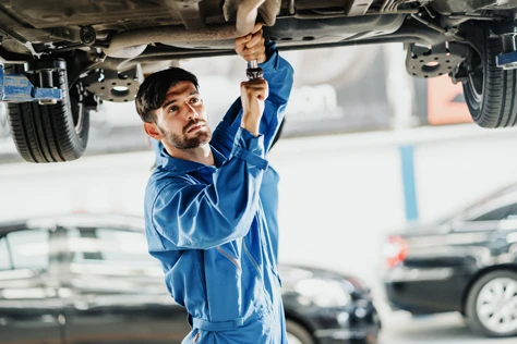 Mechanic working under car