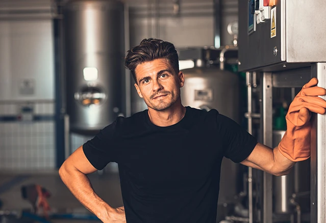 Young man posing in manufacturing plant