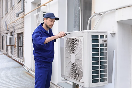 mechanic repairing ductless air conditioning system